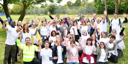 All 50 members of staff at Courage Park with their hands up