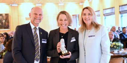 Property award winner receiving award from principal and chair of trustees