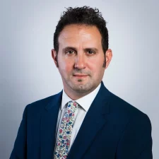 Professor Samer Bagaeen poses for professional headshot in suit and tie