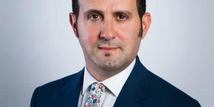Professor Samer Bagaeen poses for professional headshot in suit and tie