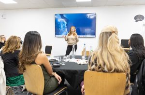 Michaela Wain speaking to a room of young women. Image supplied by Design and Build